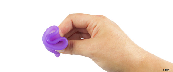 Studio shot of an isolated woman hand holding a menstrual cup
