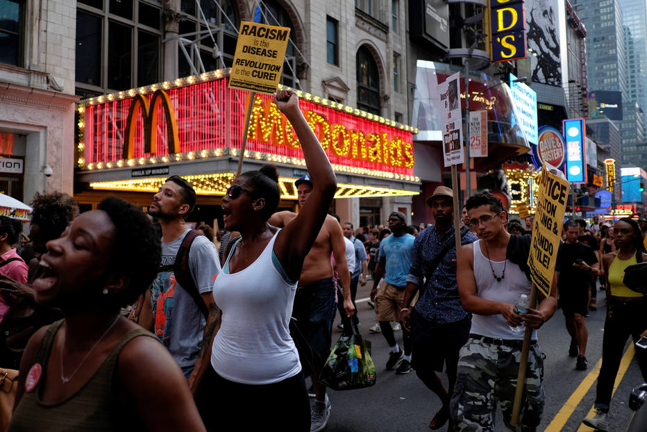People take part in a protest against the killings of Alton Sterling and Philando Castile during a march through Times Square in New York July 7, 2016. REUTERS/Eduardo Munoz